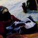 Two-year-old Kale Barlow sits in a sled and stays warm while watching hockey during the Michigan Pond Hockey Classic at Whitmore lake on Saturday, Feb. 9. "He loves hockey," his mother Sarah says. Daniel Brenner I AnnArbor.com
